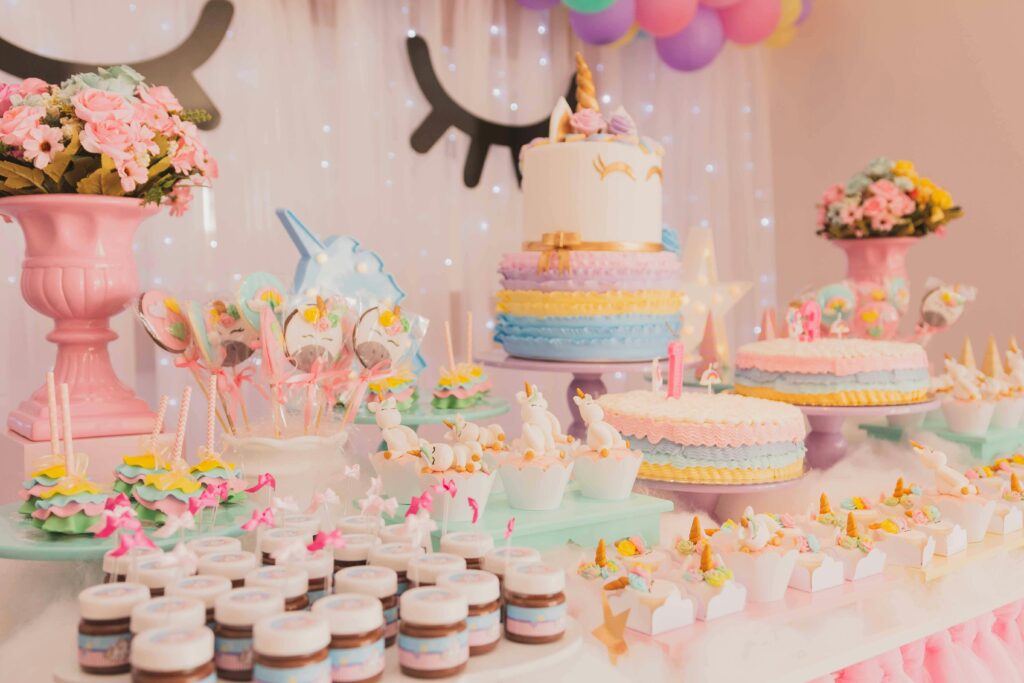 pexels-photo-1857157-1857157 A vibrant unicorn-themed birthday party setup with cakes, cupcakes, and decorations.