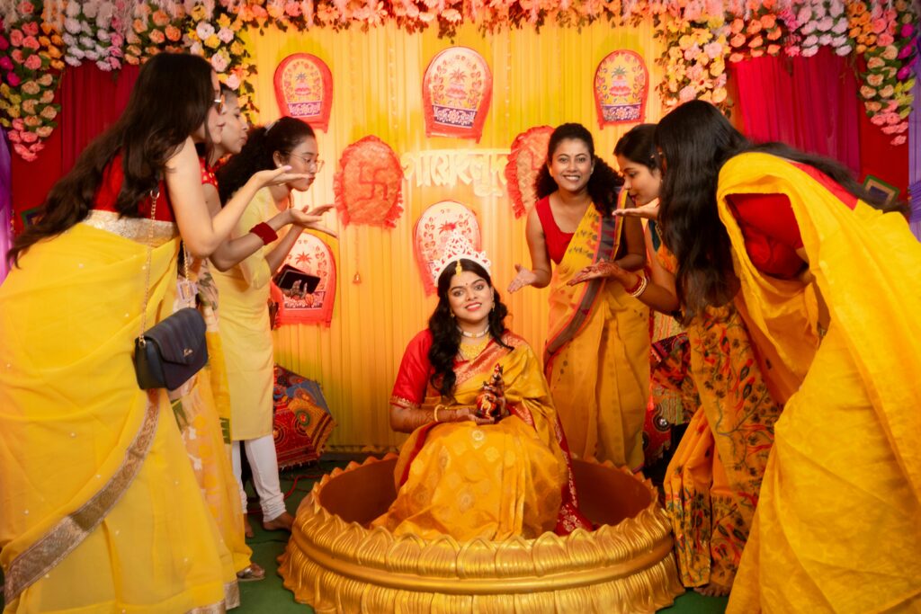 pexels-photo-30169488-30169488 Vibrant Indian engagement ceremony with women in traditional attire celebrating together.