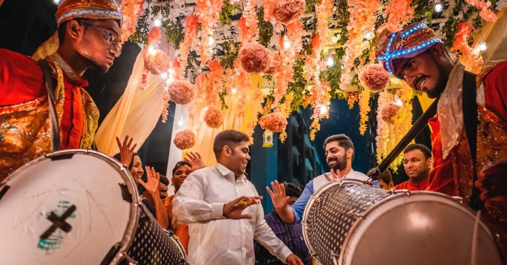 Energetic Indian wedding celebration with festive drummers and colorful decorations in Kolkata.